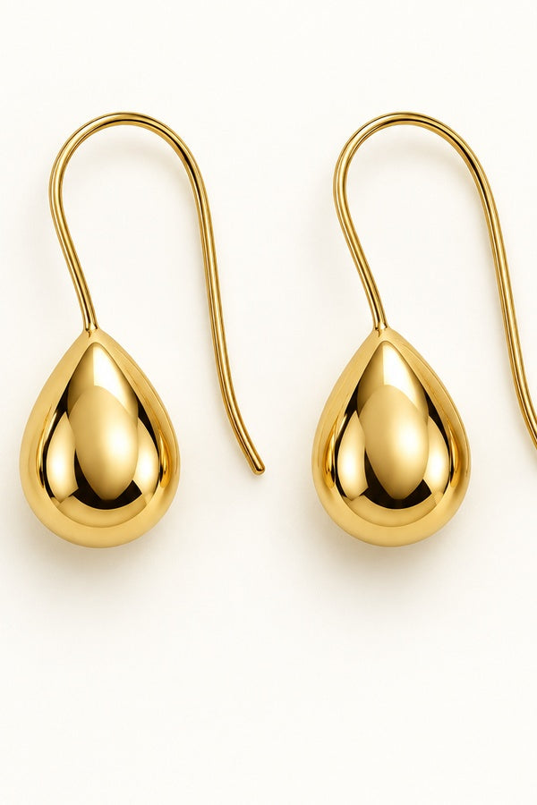 Kristy Earrings gold, close-up on ivory background